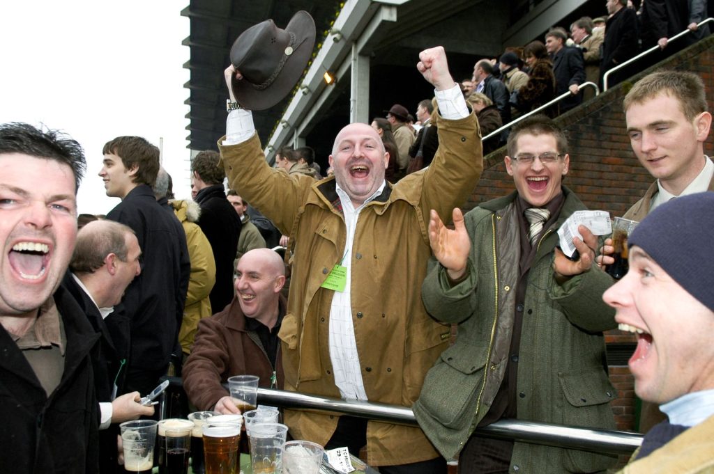 Racegoers celebrating a winner at a jump racing meeting